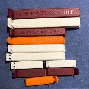 The Pampered Chef Assorted 11 Bag Clips - Burgundy, White, and Orange